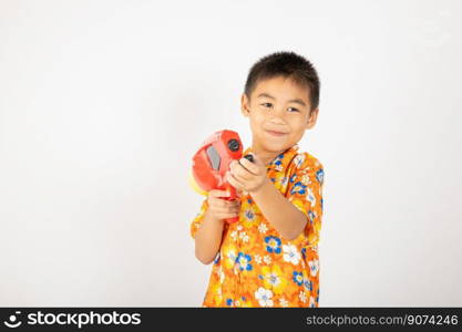 Happy Songkran Day, Asian kid boy with floral shirt hold water gun, Thai child funny hold toy water pistol and smile, isolated on white background, Thailand Songkran festival national culture concept