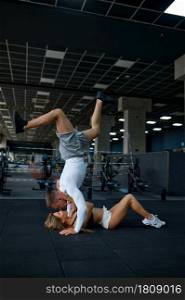 Happy sportive couple hugs, training in gym. Athletic man and woman on workout in sport club, active healthy lifestyle, physical wellness. Happy sportive couple hugs, training in gym
