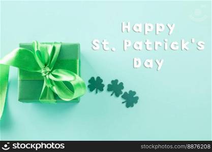 Happy St Patricks Day decoration background concept. shamrocks leaves holiday symbol with copy space on pastel background, above view gift box green clover leaves