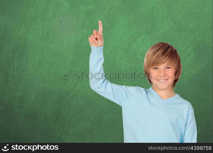 Happy student asking to speak with a green blackboard of background