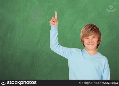 Happy student asking to speak with a green blackboard of background
