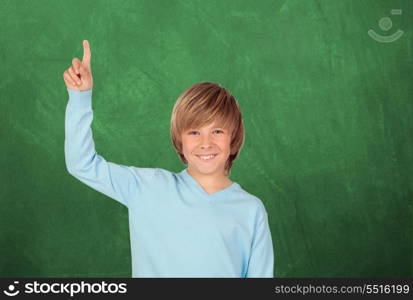 Happy student asking to speak with a green blackboard of background