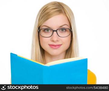 Happy student girl reading book in glasses