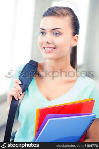 happy student girl with school bag and color folders. student girl with school bag and color folders