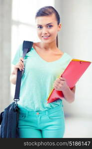 happy student girl with school bag and color folders. student girl with school bag and color folders