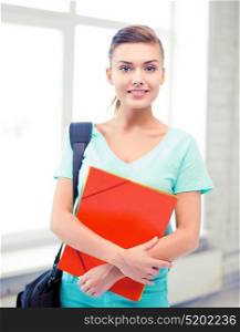 happy student girl with school bag and color folders. student girl with school bag and color folders
