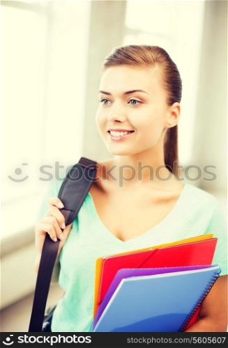 happy student girl with school bag and color folders
