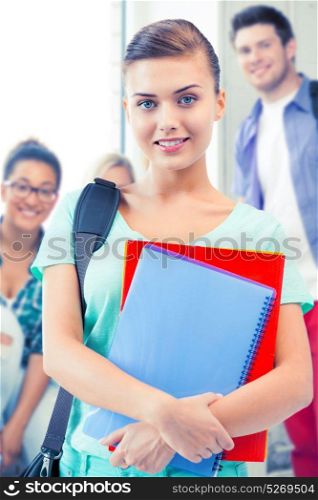 happy student girl with school bag and notebooks at school. student girl with school bag and notebooks