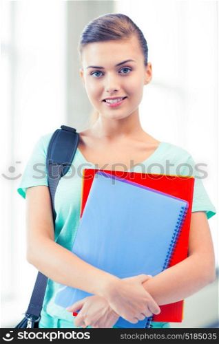happy student girl with school bag and notebooks. student girl with school bag and notebooks