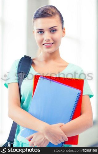 happy student girl with school bag and notebooks. student girl with school bag and notebooks