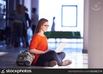 happy student girl working on laptop computer at modern school university indoors