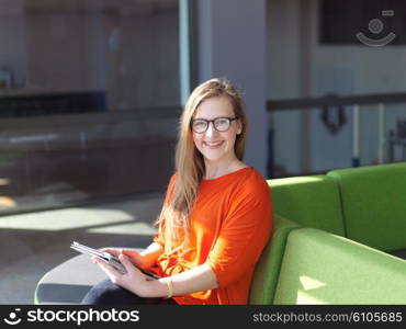 happy student girl working on tablet computer at modern school university indoors