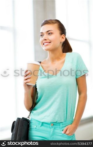 happy student holding take away coffee cup