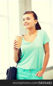 happy student holding take away coffee cup