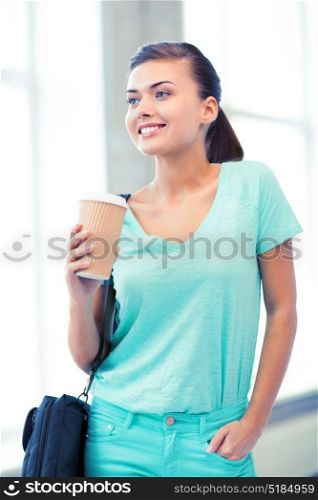 happy student holding take away coffee cup. student holding take away coffee cup