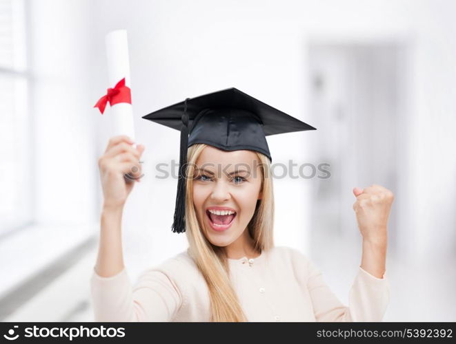 happy student in graduation cap with certificate