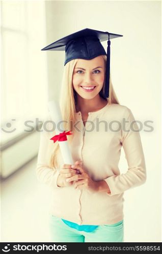 happy student in graduation cap with certificate