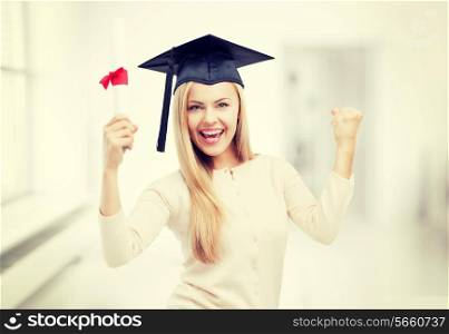 happy student in graduation cap with certificate