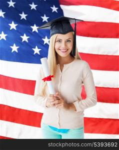 happy student in graduation cap with certificate over american flag