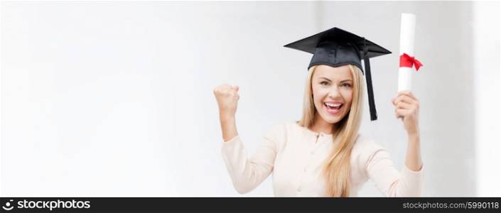 happy student in graduation cap with certificate. student in graduation cap with certificate