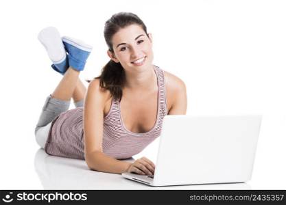 Happy student lying in the floor working in a laptop, isolated over a white background