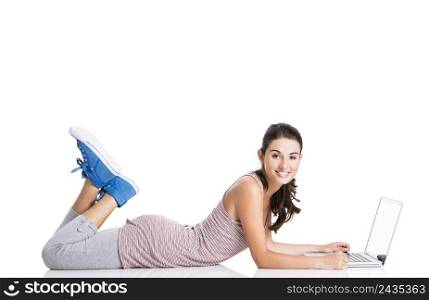 Happy student lying in the floor working in a laptop, isolated over a white background