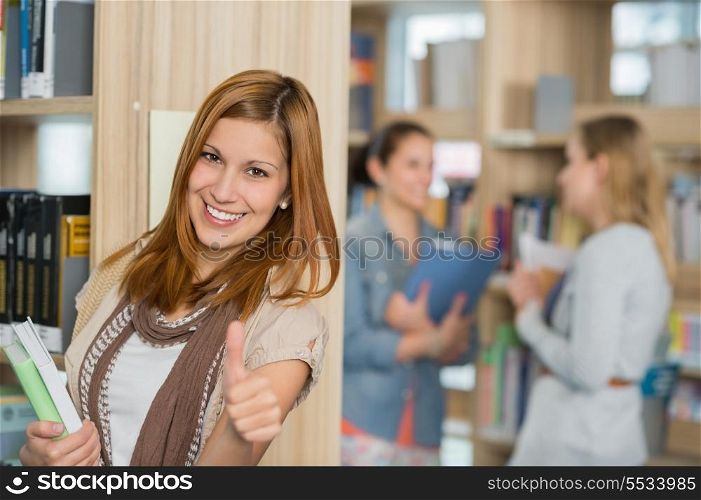 Happy student showing thumb up in college library
