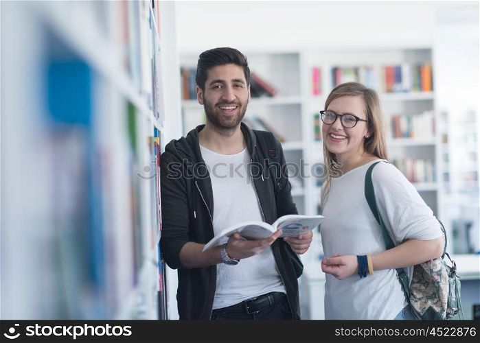happy students couple in school library have discussion about book