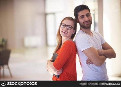 happy students couple standing together at university campus interior