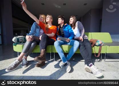 happy students group taking selfie with smartphone and tablet computer