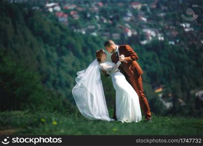 happy stylish bride and groom running and having fun in mountains on summer sunny day. gorgeous newlywed couple laughing, true feelings. emotional romantic moment. happy stylish bride and groom running and having fun in mountains on summer sunny day. gorgeous newlywed couple laughing, true feelings. emotional romantic moment.