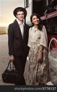 Happy stylish couple on vintage railway station