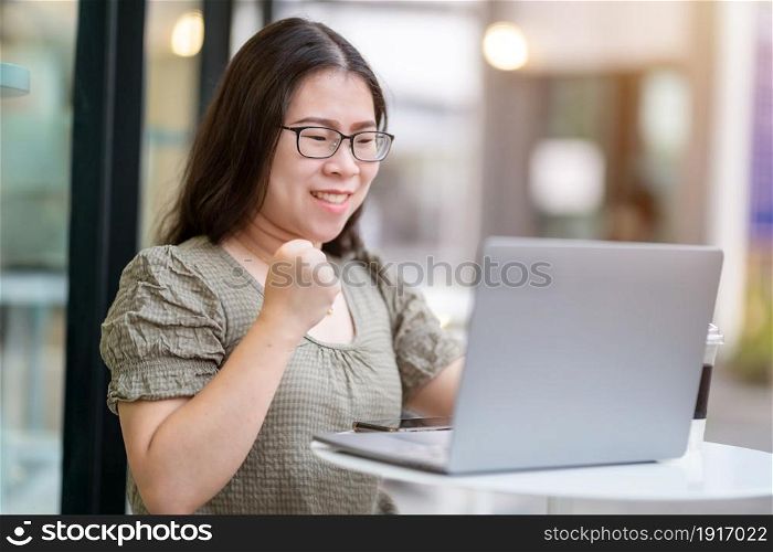 Happy successful business of asian freelance people business female expressed confidence embolden working with laptop computer sitting in coffee shop like the background,communication concept