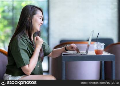 Happy successful business of asian freelance people business female expressed confidence embolden working with laptop computer sitting in coffee shop like the background,communication concept