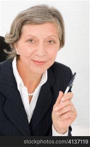 Happy successful senior businesswoman professional smart look holding pen portrait