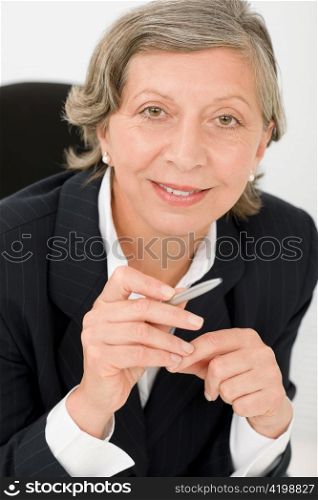 Happy successful senior businesswoman professional smart look holding pen portrait