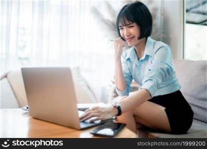 Happy successful Smiling with dental braces of asian freelance people business female casual working with laptop computer and notebook with coffee cup and smartphone in cafe interior in coffee shop
