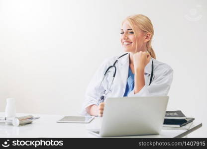 Happy successful woman doctor feels delightful in hospital or healthcare institute while working on medical report at office table. Success concept.. Happy doctor in hospital. Medical success concept.