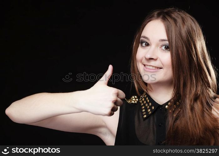 Happy successful young people concept. Satisfied positive teen girl giving thumbs up sign hand gesture on black