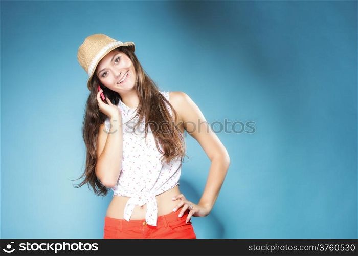 Happy summer girl teenager woman talking on mobile phone blue background