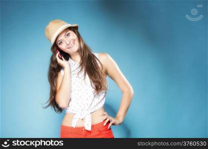 Happy summer girl teenager woman talking on mobile phone blue background