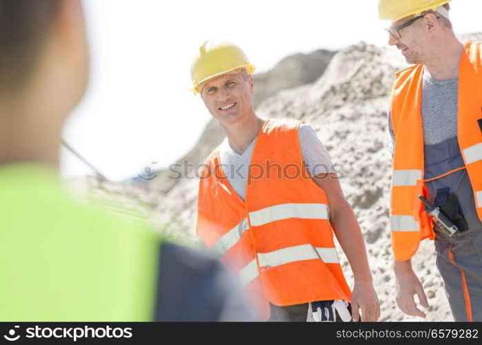 Happy supervisor with colleague at construction site