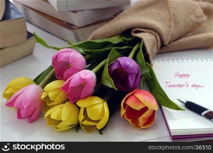 Happy teachers day with handmade tulip flower pot, stack of books, pen, message for teacher in special day of education, tulip bouquet diy from clay material