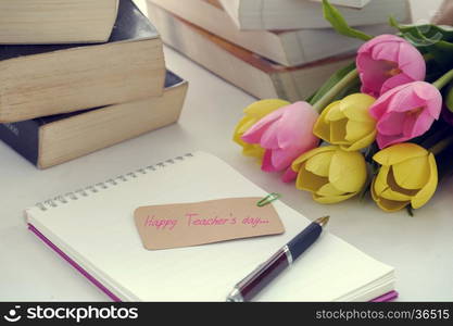 Happy teachers day with handmade tulip flower pot, stack of books, pen, message for teacher in special day of education, tulip bouquet diy from clay material