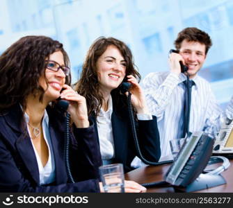 Happy team of customer service operators calling on phone.