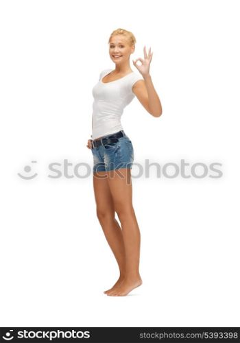 happy teen girl in blank white t-shirt showing ok sign