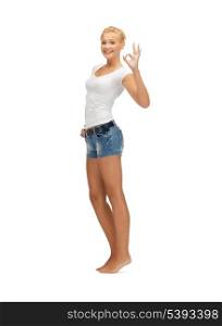 happy teen girl in blank white t-shirt showing ok sign