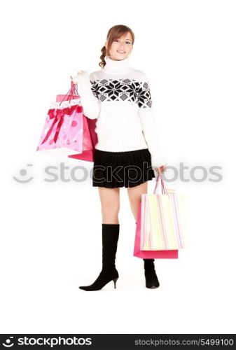 happy teen with shopping bags over white