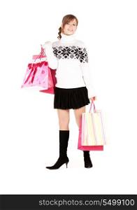 happy teen with shopping bags over white