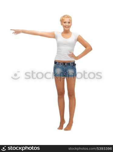 happy teenage girl in blank white t-shirt poining her finger